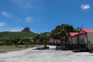 a row of houses with a mountain in the background at Kenting Dream House in Kenting