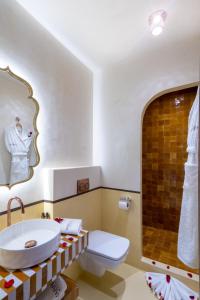 a bathroom with a sink and a toilet and a tub at Riad Mabrouk in Marrakech +123 photos