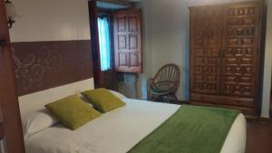 En eller flere senge i et værelse på hotel La rectoral