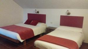 En eller flere senge i et værelse på hotel La rectoral