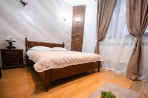 a bedroom with a bed and a brick wall at Marcos Apartments I Bathtub in Bedroom experience in Făgăraş