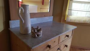 a counter with a vase on top of a dresser at Lant van Beloften in Vlissingen +11 photos