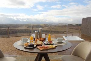 a table with breakfast foods on it on a balcony at Wine Bubble in Cuzcurrita-Río Tirón