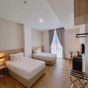 a hotel room with two beds and a window at S Hotel in Johor Bahru