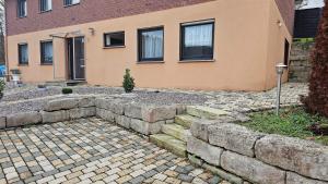 een huis met een stenen keermuur en een trap ervoor bij Apartment Wildgrund in Siegen