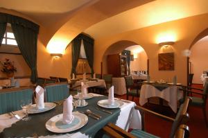 a dining room with tables and chairs in a restaurant at Hotel Dvorak Cesky Krumlov in Český Krumlov