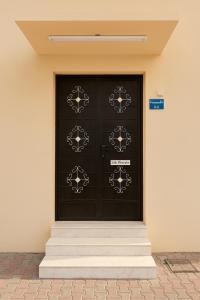 a pair of black doors on a building at Sikka Hostel in Muscat