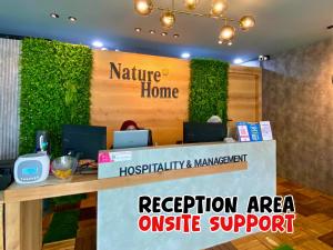 a reception area with a green wall at Nature Home 2 - Swiss Garden Resort Residences Beachfront Villa - Weekend Free Breakfast in Kuantan +102 photos