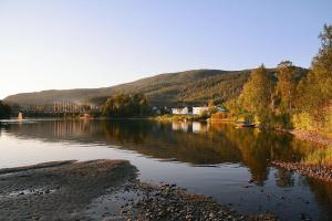 a view of a river with a town and a bridge at Rundhaug Gjestegard in Rundhaug