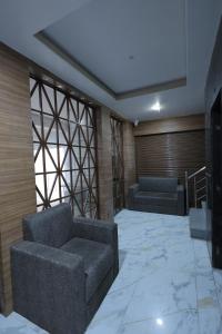 a living room with two couches and a television at Hotel Pearl -Jaipur Pink City Centre in Jaipur +27 photos