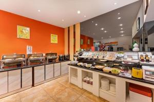 a restaurant with a counter with food on display at 7 Days Premium Zibo Jinjing Avenue the Mixc in Zibo