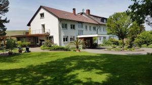 a large white house with a green lawn at Landhaus Friede in Müllheim