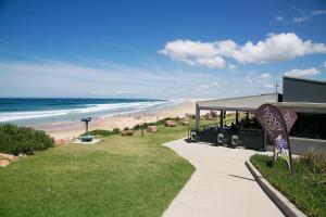 a view of a beach with a train station and the ocean at Birubi Beach Holiday Park in Anna Bay