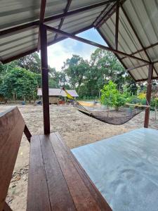a picnic table and a hammock in a playground at Phayam Local homestay in Ko Phayam