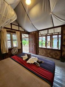 a bedroom with a large bed in a tent at Phayam Local homestay in Ko Phayam +9 photos
