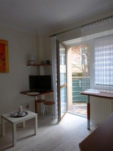 a living room with a sliding glass door to a patio at Apartament 210 in Krynica Zdrój