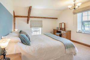 a bedroom with a white bed and a window at 1 Bed in Nantygwreiddyn oc-bow49 in Sennybridge