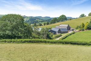 a farm in the middle of a green field at 1 Bed in Nantygwreiddyn oc-bow49 in Sennybridge