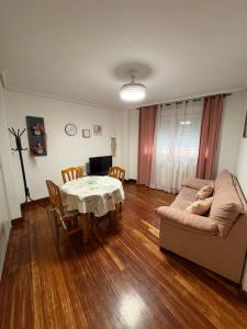a living room with a table and a couch at Estrella Mudejar in Teruel