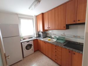 a kitchen with a sink and a washing machine at Estrella Mudejar in Teruel +5 photos
