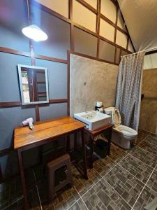a bathroom with a sink and a toilet at Phayam Local homestay in Ko Phayam