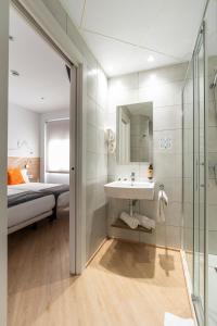 bagno con lavandino, letto e doccia di Hostal Sans a Barcellona Altre 70 foto