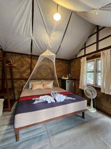 a bedroom with a bed in a tent at Phayam Local homestay in Ko Phayam