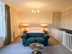 a living room with a couch and a bed at The Atholl Palace in Pitlochry