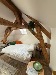 a bedroom with a bed with wooden beams at Domaine à la Loëx in Geneva