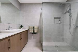 a bathroom with a shower and a sink at Poolside Luxury Villa - Solar Pool Beach 3min in Mornington