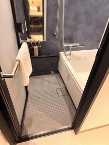 a bathroom with a tub and a sink at Hotel Grand Tiara Minaminagoya in Anjomachi +45 photos