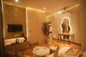 a room with a living room with a table and a tv at Meghnad By Padmaraag in Nalbāri