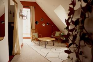 Un pasillo con una mesa y sillas en una habitación. en Les Chambres du parc, en Monnières