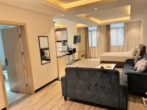 a living room with a couch and a living room with at Bentark Hotel in Addis Ababa
