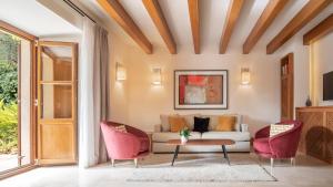 a living room with a couch and two chairs at Castell Son Claret - The Leading Hotels of the World in Capdellá