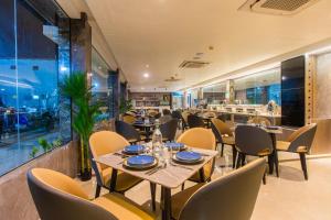 a restaurant with tables and chairs and a bar at Lonuhiri at Dhigurah in Dhigurah