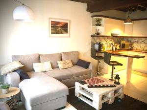 a living room with a couch and a table at Le Charmant Zola Hyper Centre classé in Troyes +15 photos