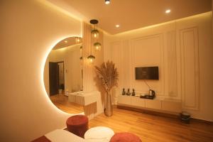 a living room with a mirror and a vase at Meghnad By Padmaraag in Nalbāri +16 photos