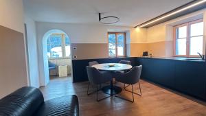 a kitchen with a table and chairs in a room at Apartment Cesa Collina Family Retreat in Ortisei