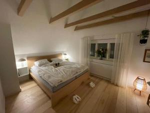 a bedroom with a large bed and a window at Modern & Unique property in Odense centrum - FREE PARKING in Odense