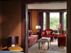 a living room with a couch and a chair at 45 Park Lane - Dorchester Collection in London