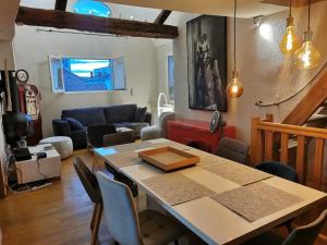 a living room with a table and a couch at Annecy Carnot in Annecy
