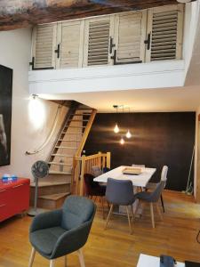 a room with a table and chairs and a staircase at Annecy Carnot in Annecy