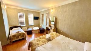 ein kleines Zimmer mit zwei Betten und einem Spiegel in der Unterkunft Garden Sheki Hotel in Şəki