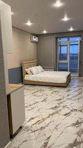 Giường trong phòng chung tại Akzhol