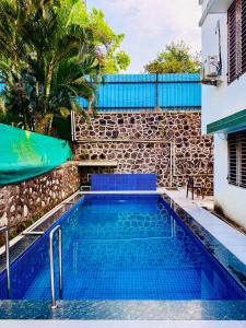 a swimming pool in front of a building at Emerald Villa by Crystal Villas in Jāmb +10 photos