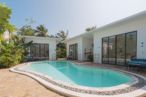 an image of a swimming pool in front of a house at 4Suns villas in Ahangama