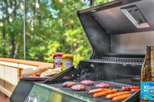a grill with hot dogs and donuts and a bottle of beer at Large Family Friendly House on the Fairway Hideout in Lakeville