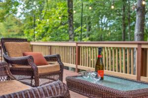 a bottle of wine sitting on a table on a deck at Large Family Friendly House on the Fairway Hideout in Lakeville