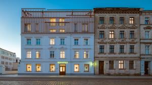 a large white building with its lights on at B&B HOTEL Leszno in Leszno